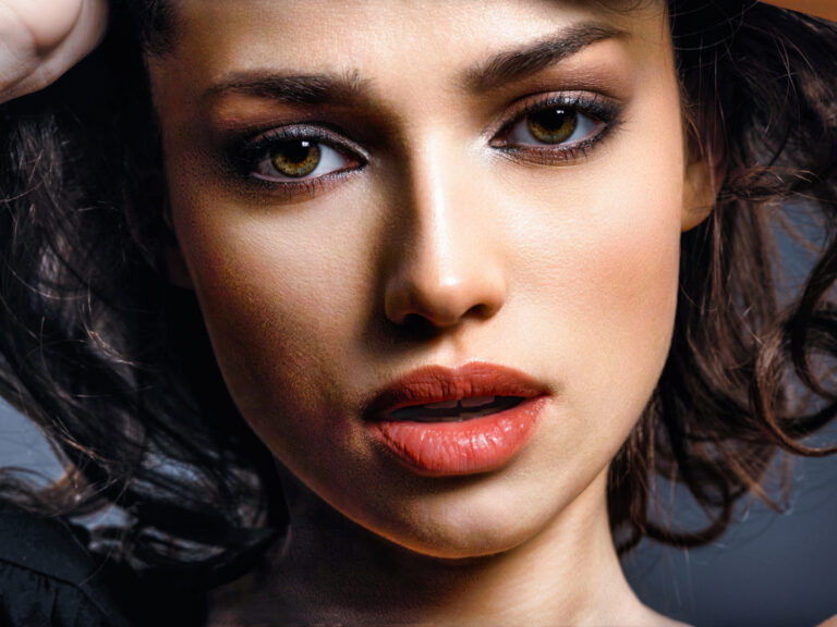 beautiful brunette woman with brown eyes fashion model with smokey makeup closeup portrait pretty woman looks camera