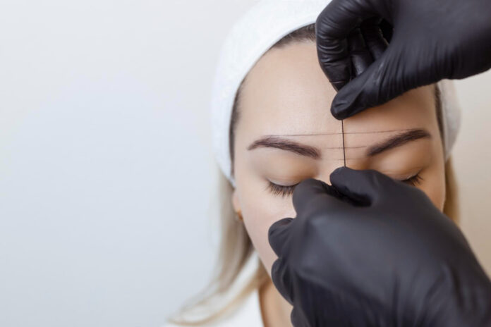 eyebrow tattooing permanent eyebrow makeup master applies contour with thread clients