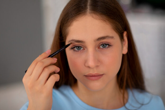 front view girl doing her eyebrows