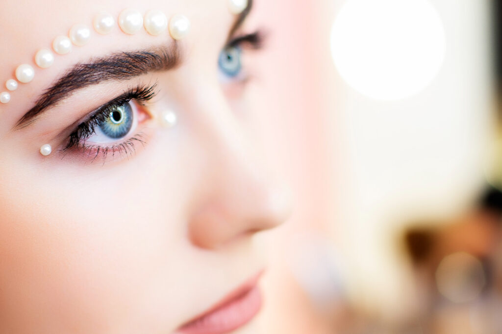 makeup with pearl rhinestones face