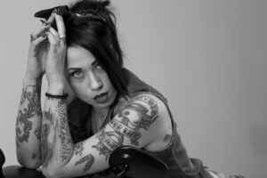 portrait woman sitting against wall