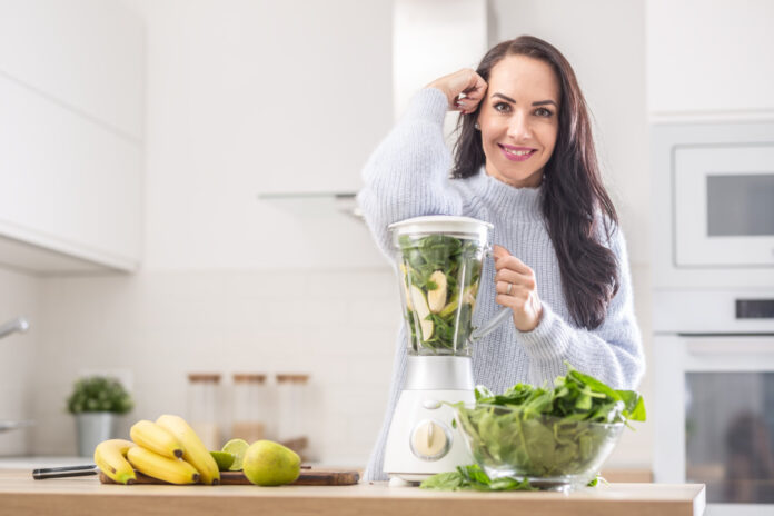 vitamins packed blender ready be mixed into smoothie by beautiful woman
