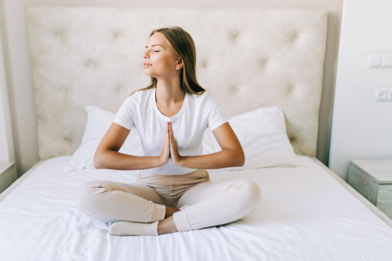 young woman doing yoga exercises bed home