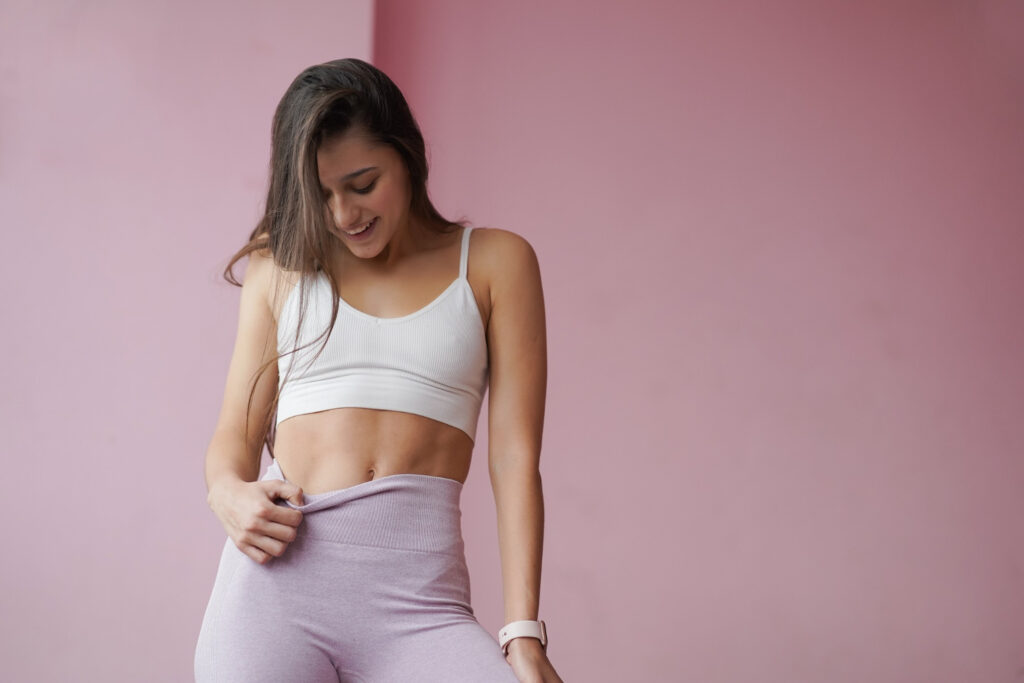 slim beautiful woman posing dressed sportswear