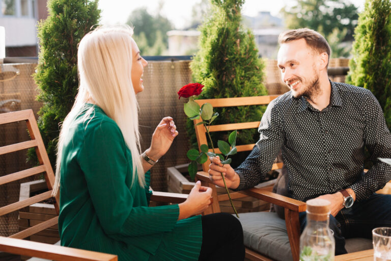 young man giving beautiful rose attractive lady