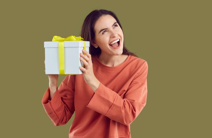 i,will,guess,what,is,inside.,interested,cheerful,woman,shakes